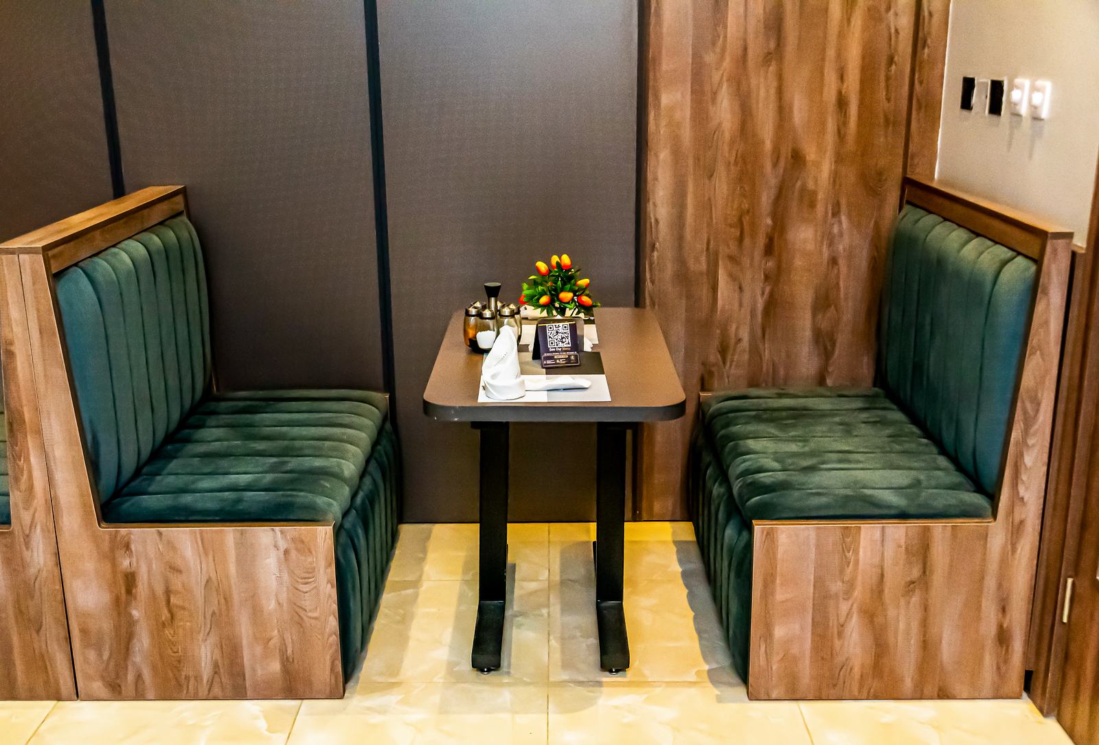 Green upholstered dining booth at Arena Continental