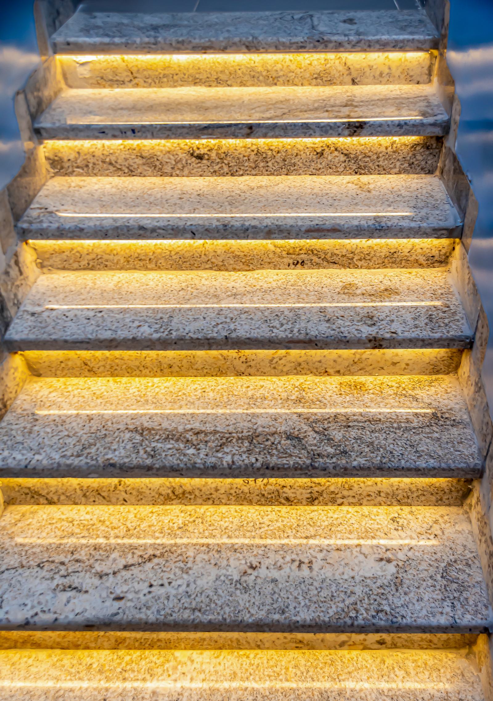 Warm illuminated stone stair detail at Arena Continental